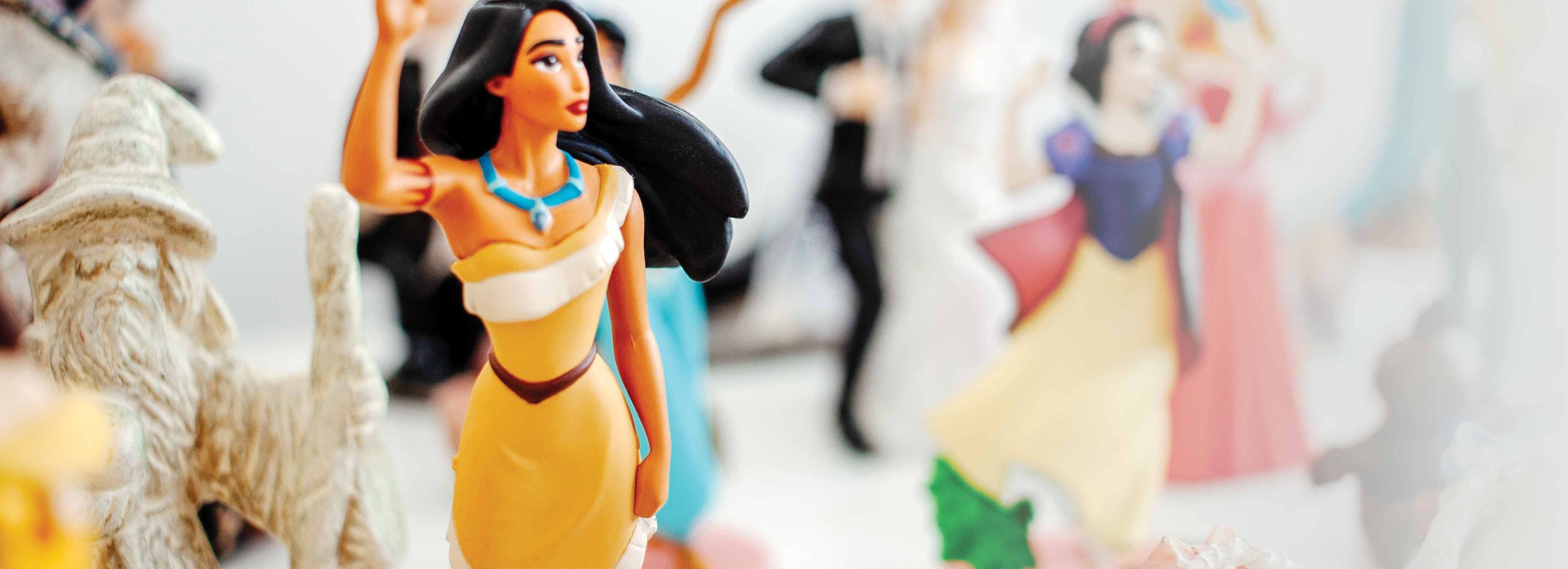 Various toy figures including Disneys Pocahontas and Snow White