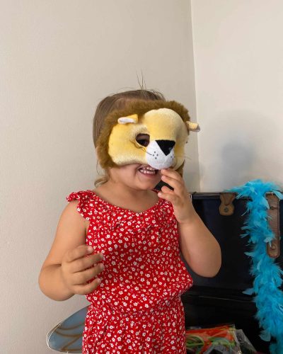 Girl wearing lion mask